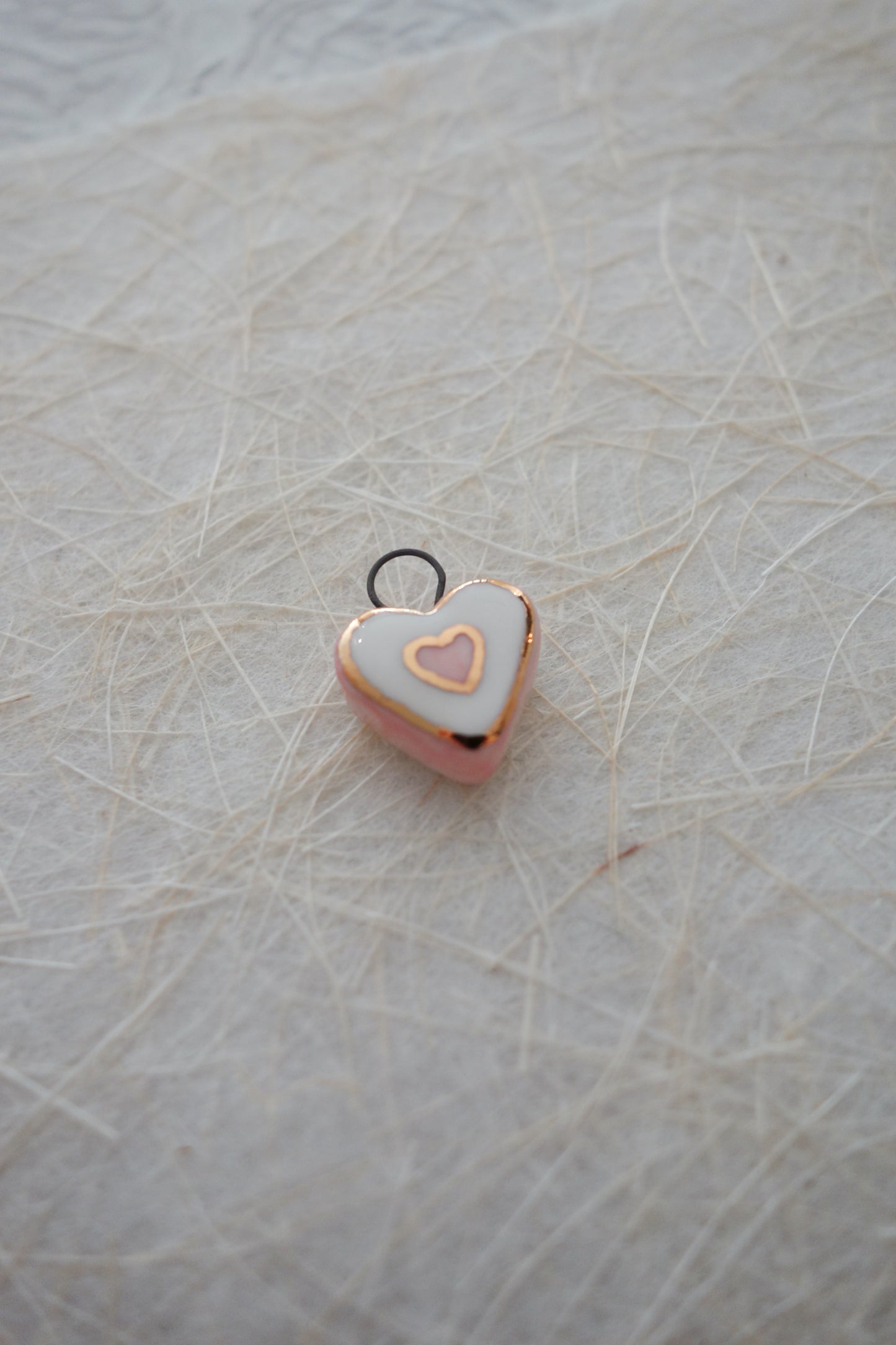 Intertwined hearts ceramic charm necklace